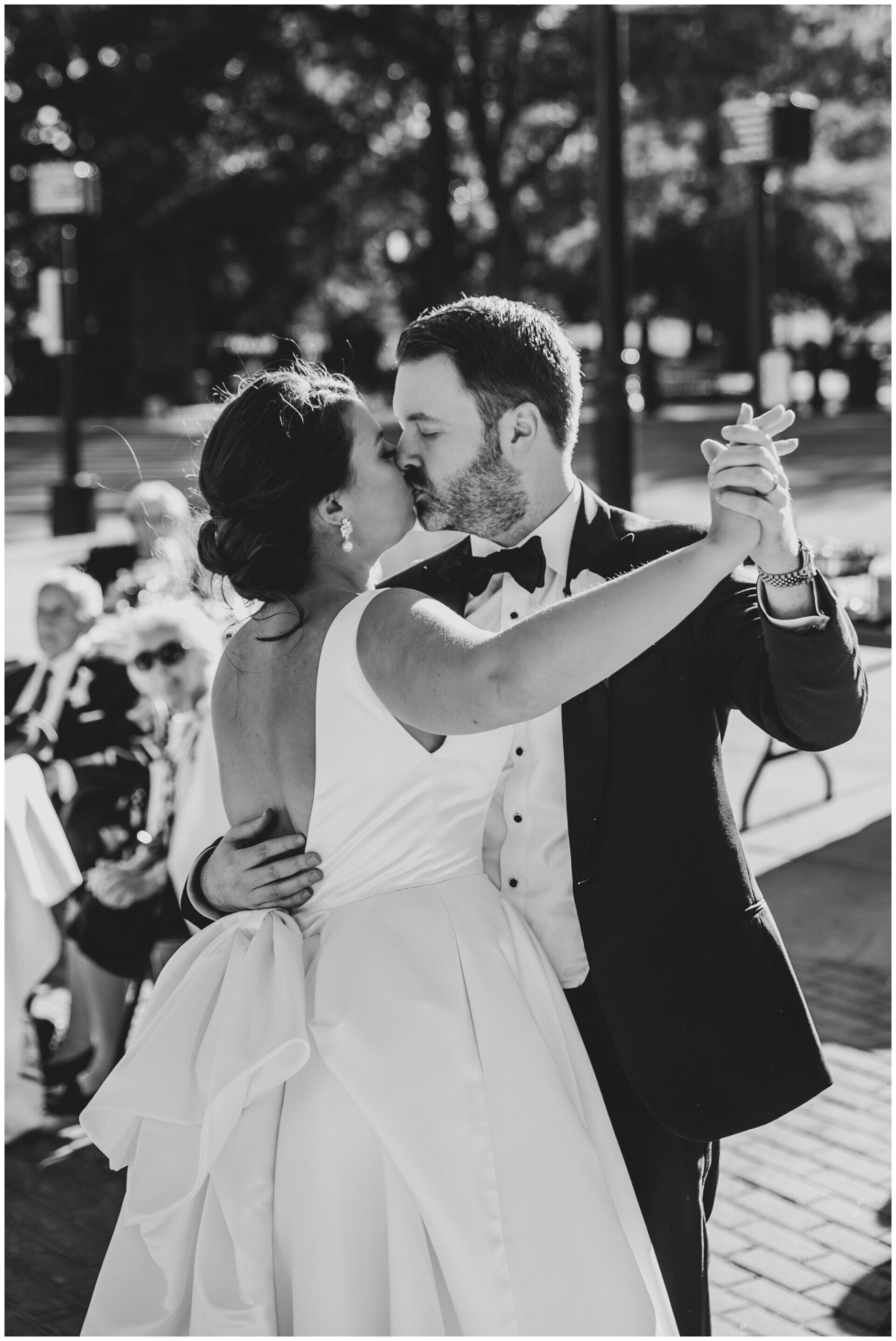 Bride and groom dancing outdoors during a wedding ceremony