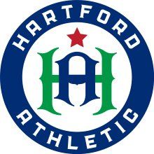 Hartford Athletic circular logo with blue ring, green-and-blue “HA,” and red star