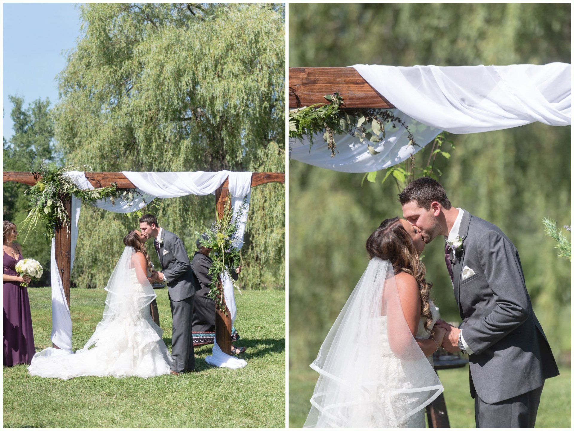 Bride and groom kiss under a decorated wedding arch in a sunny garden.