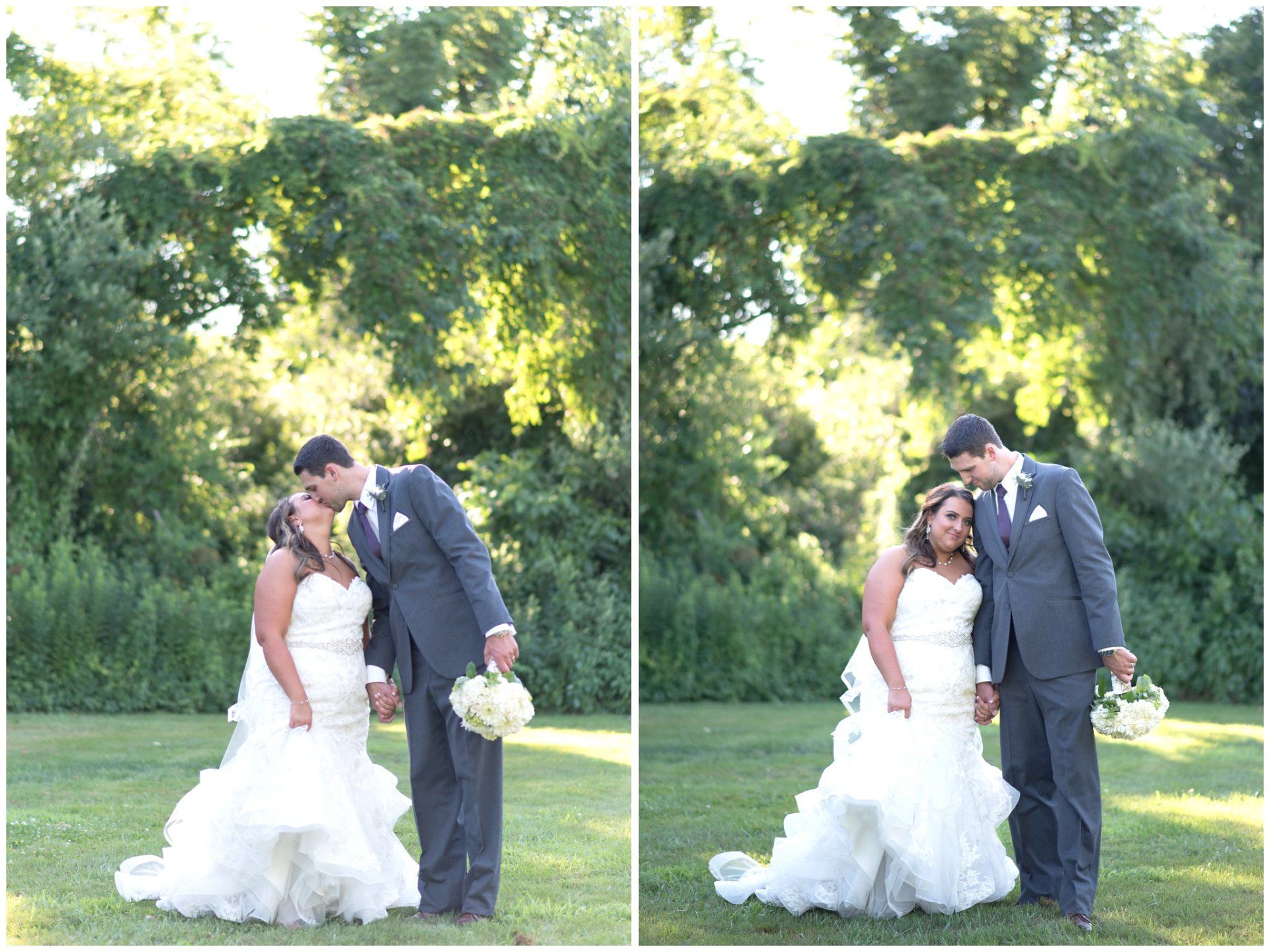 Bride and groom kissing in wedding attire outdoors by a tree, holding bouquet