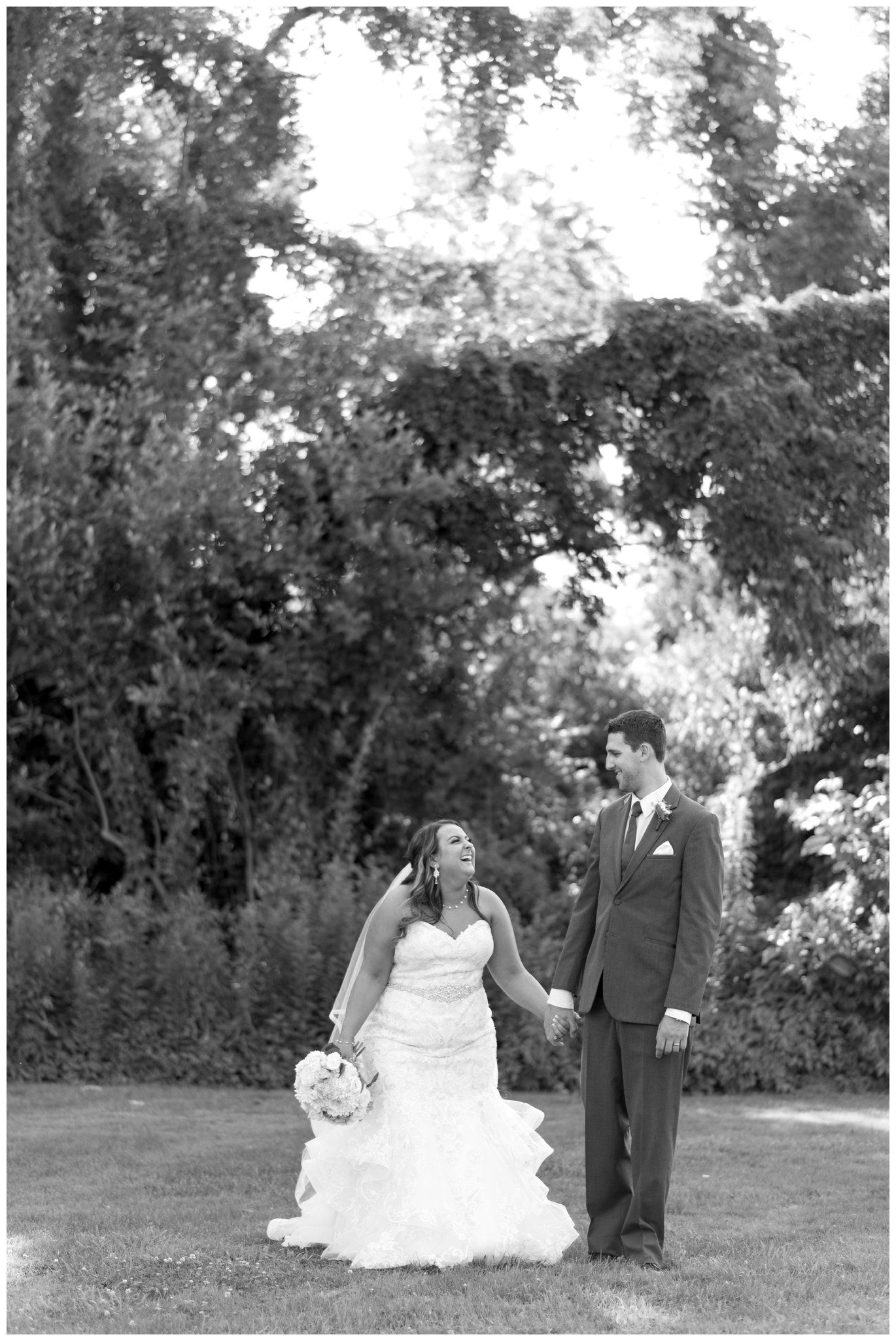 Bride and groom holding hands outdoors in a garden ceremony