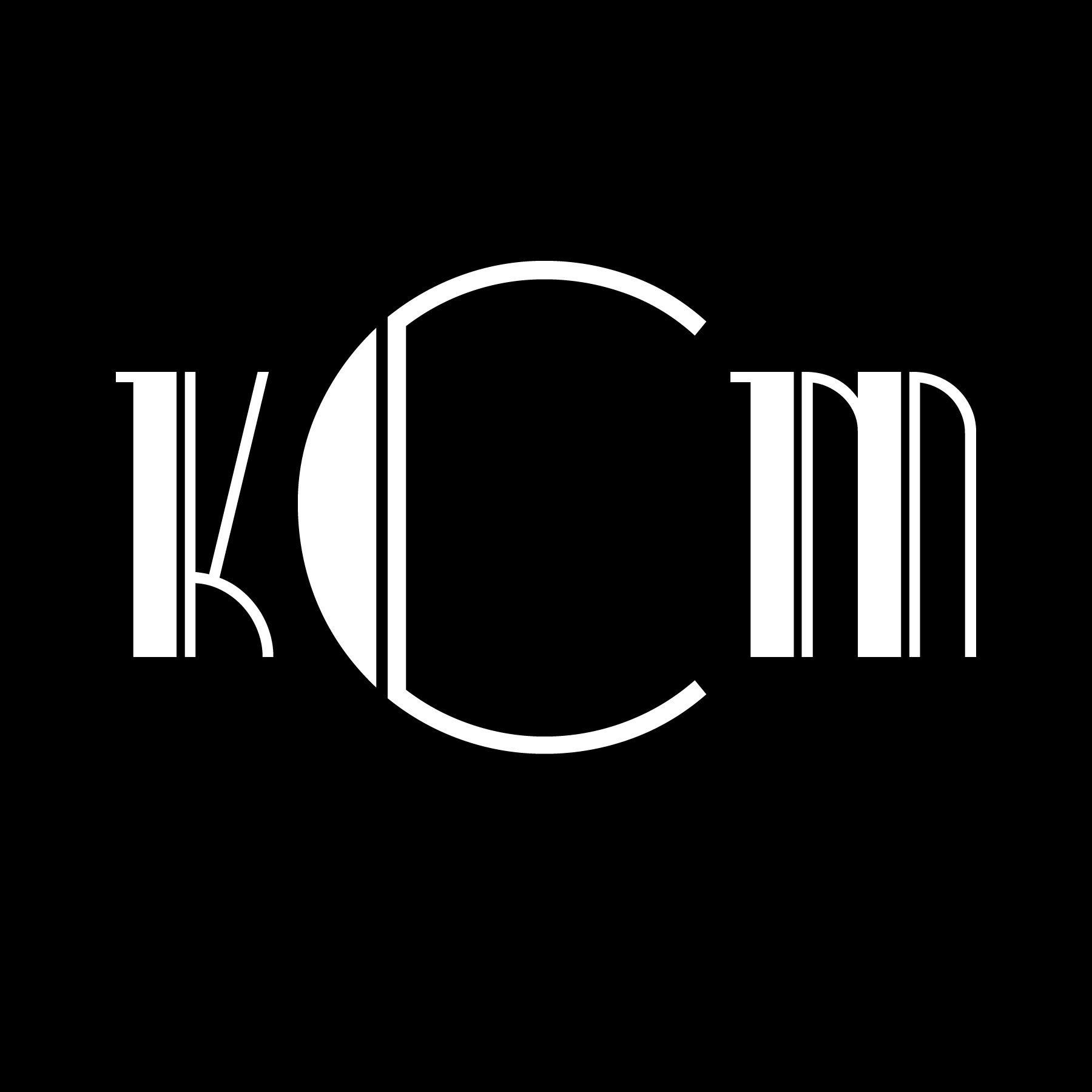White stylized “KCM” letters on a black background.