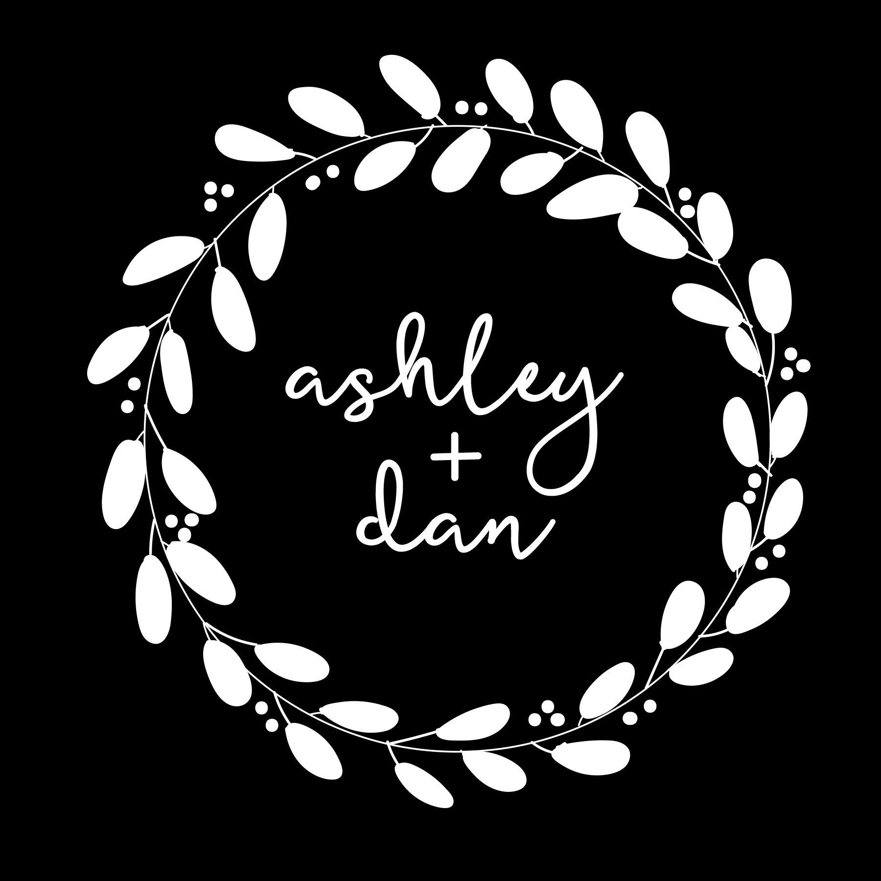 White floral wreath with “ashley + dan” in cursive on a black background