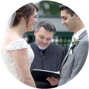 Bride and groom exchanging vows with officiant during a wedding ceremony
