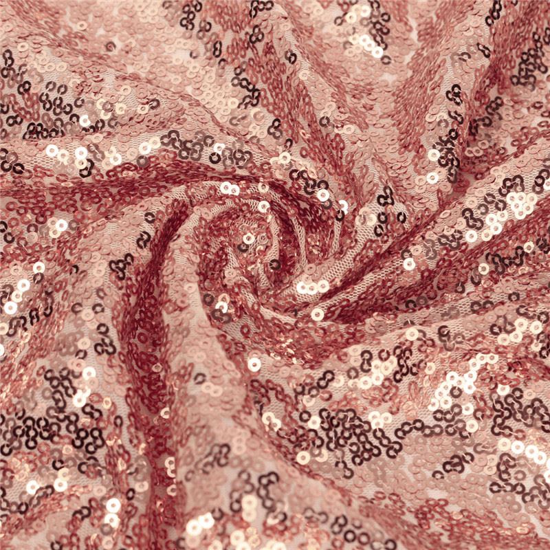 Abstract pink and burgundy spiral pattern with shimmering sequins