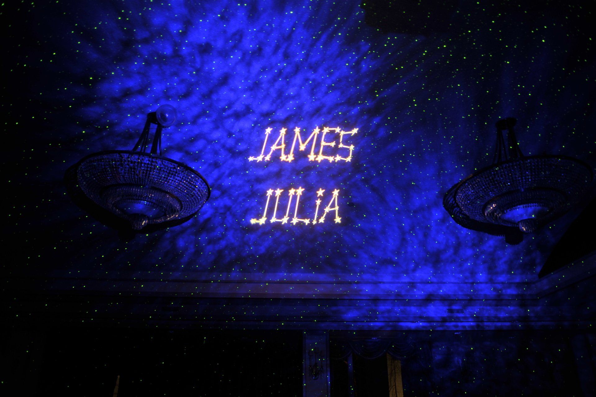 Blue-lit wall with the names “JAMES” and “JULIA” projected in white letters