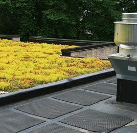 Man cleaning a flat roof