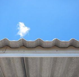 Man cleaning a flat roof