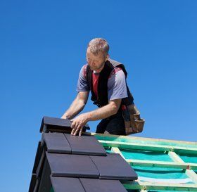 Man cleaning a flat roof