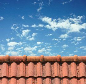 Man cleaning a flat roof
