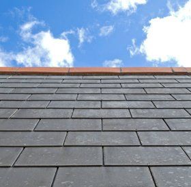 Man cleaning a flat roof
