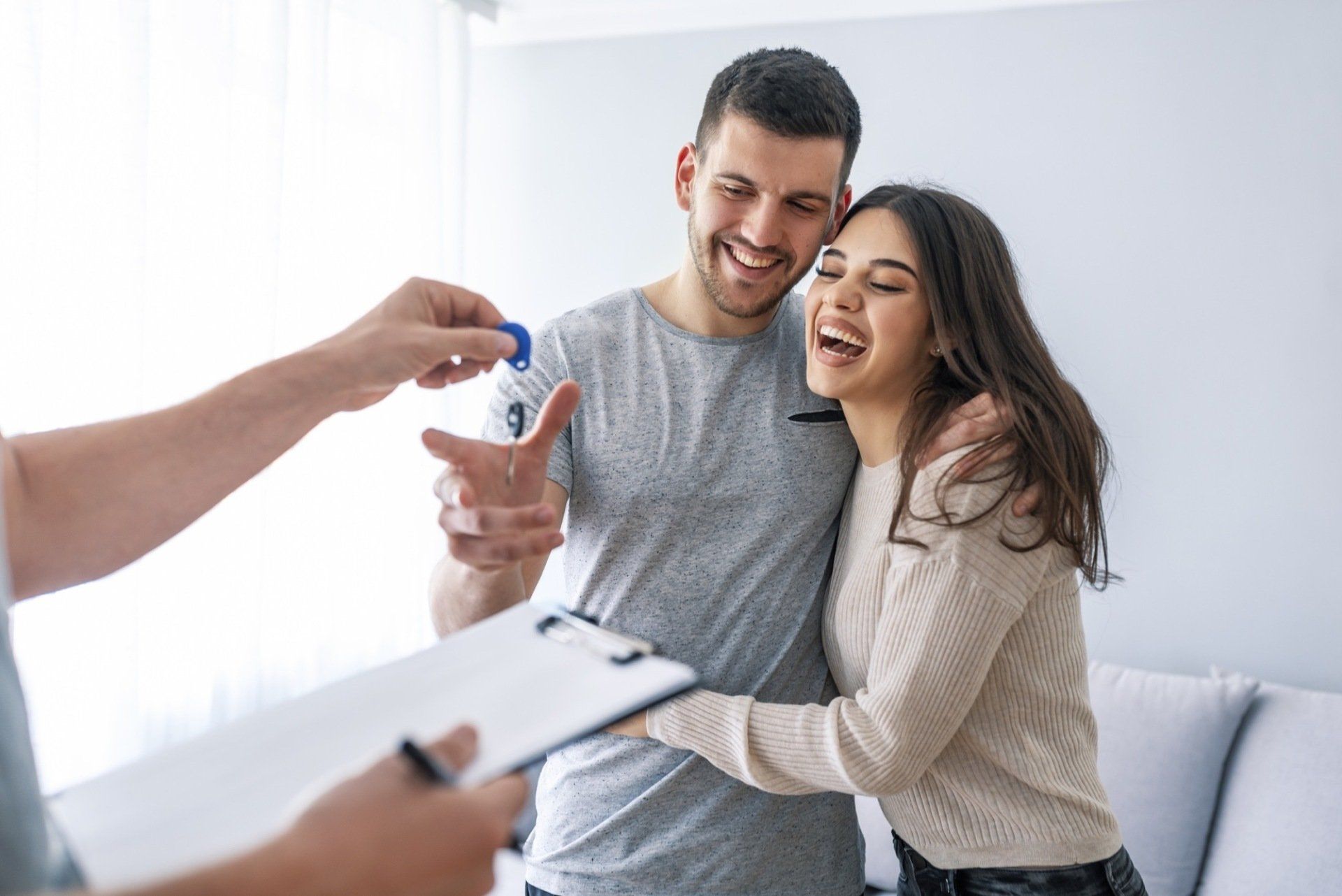 happy couple getting keys
