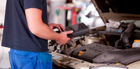 computer car engine diagnostics done by a mechanic