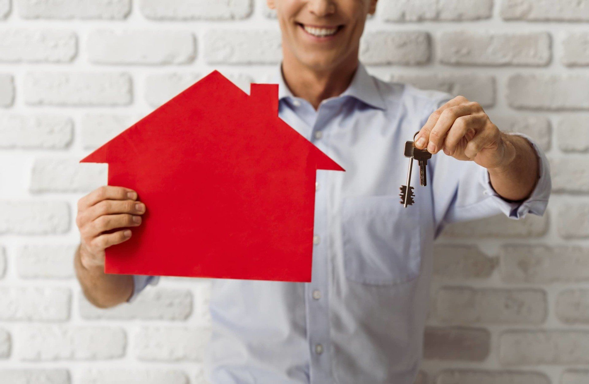 guy holding house photo