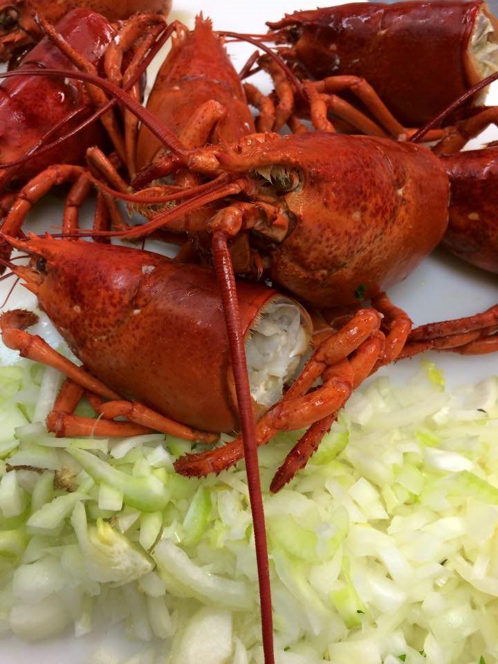A close up of lobsters on a plate with lettuce
