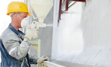 spraying an exterior wall with textured coating