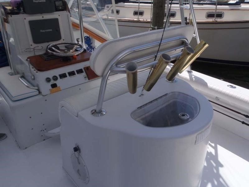 A boat with a toilet and fishing rods on it