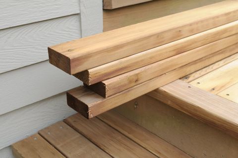 Wood Siding — Wood Stacked On Porch For Home Renovation Project in Houston, TX
