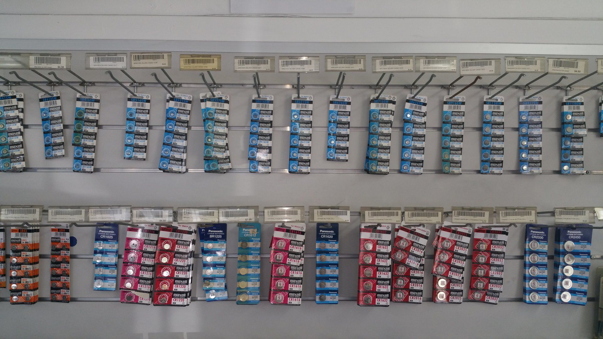 A bunch of batteries are lined up on a wall