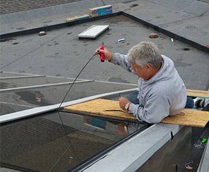 Window Sales — Man Installing New Windows in Byron Center, MI Window Sales — Man Installing New Windows in Byron Center, MI