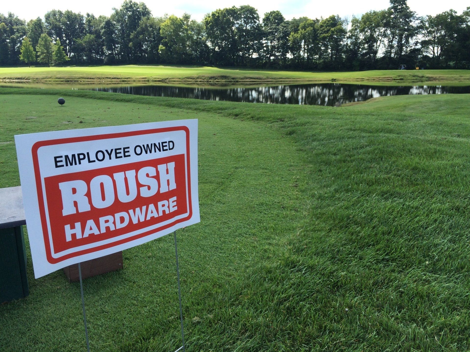 A sign that says employee owned roush hardware on it