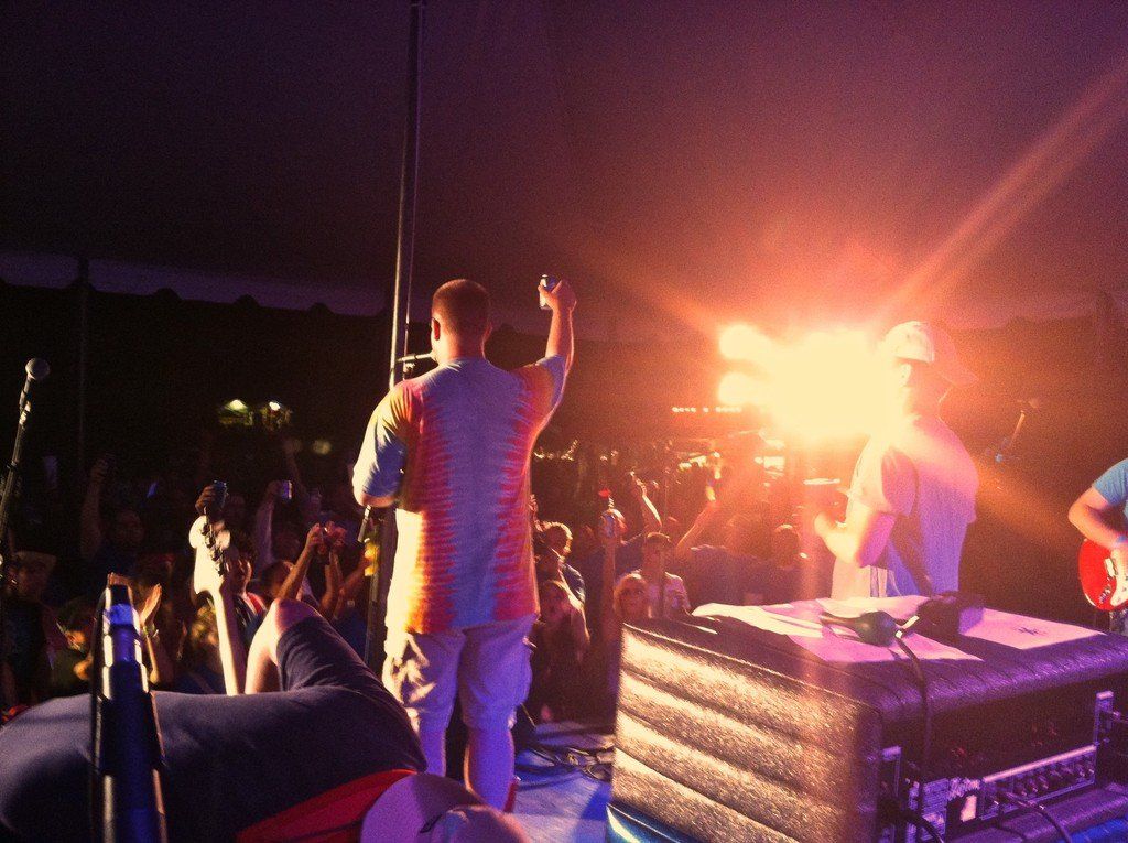 A man singing into a microphone in front of a crowd