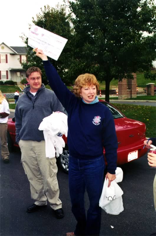 A woman holds up a sign that says
