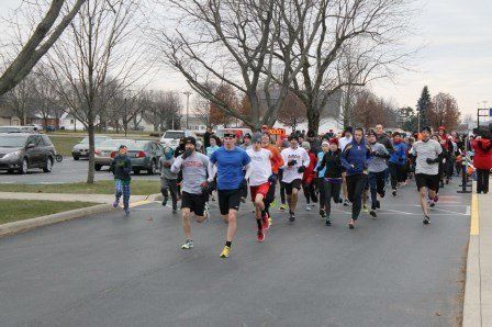 A group of people are running down a street