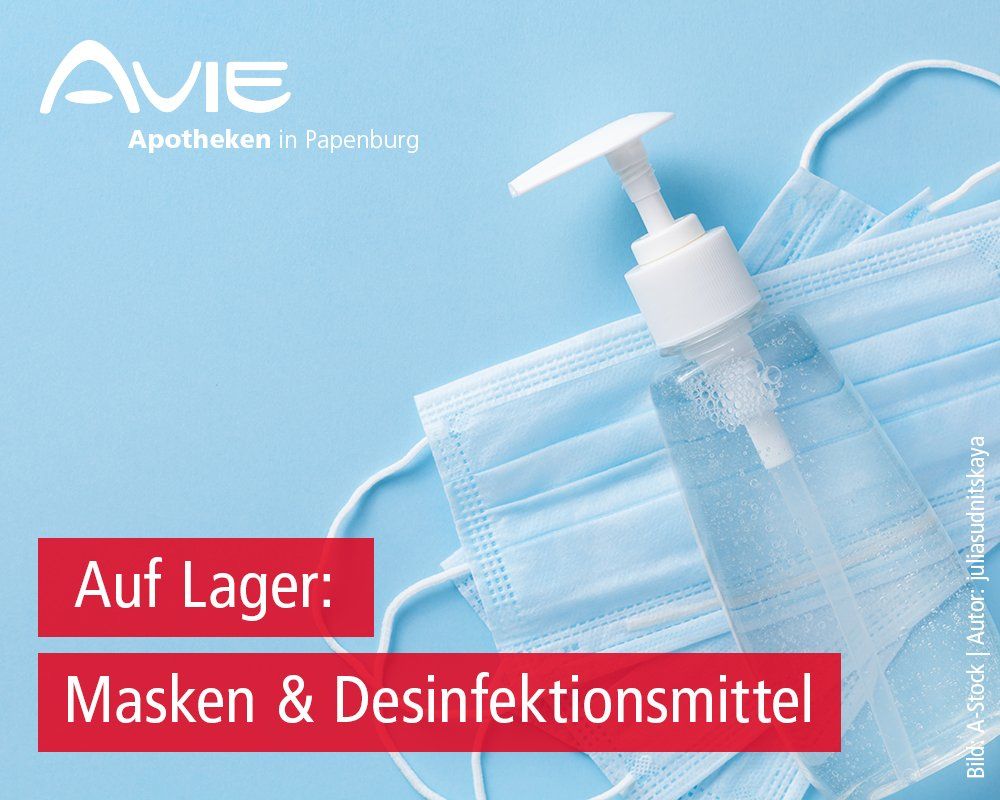 Eine Flasche Handdesinfektionsmittel steht neben einem Stapel Masken