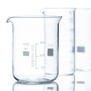A clear glass beaker with approx. vol written on it