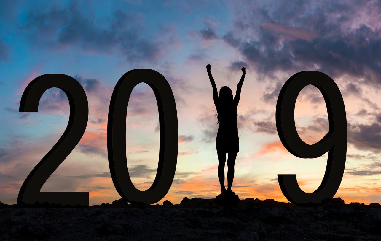 A silhouette of a person standing in front of the number 2019