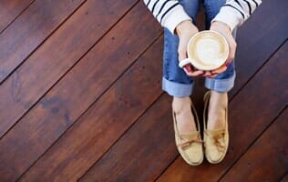 Woman Sitting On The Floor — Hardwood Floors in Mahomet, IL