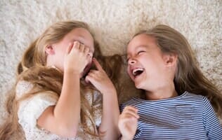 Two Girls Laughing — Carpets in Mahomet, IL Two Girls Laughing — Carpets in Mahomet, IL