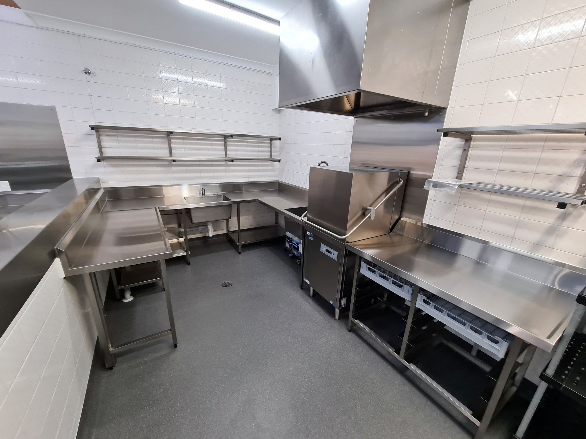 A kitchen with stainless steel counter tops and appliances