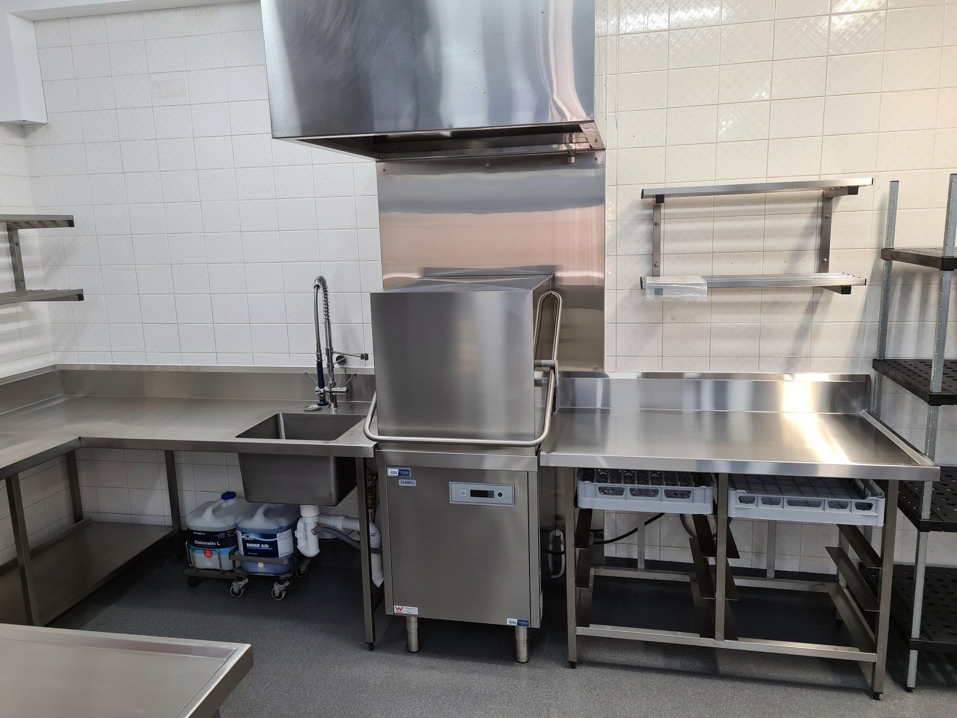 A kitchen with stainless steel appliances and a sink.