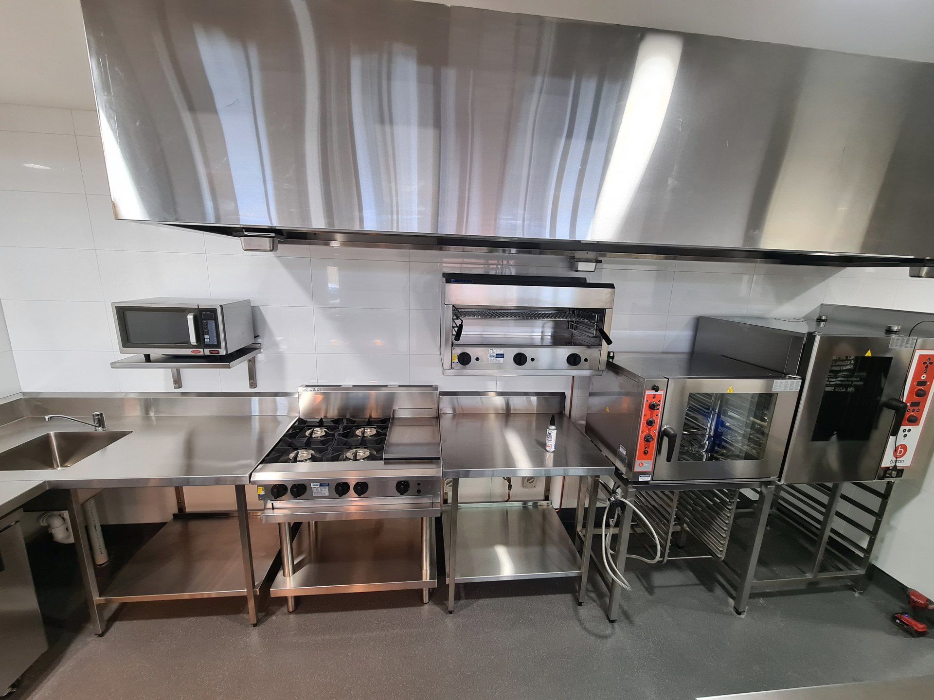 A kitchen with stainless steel appliances and a sink.