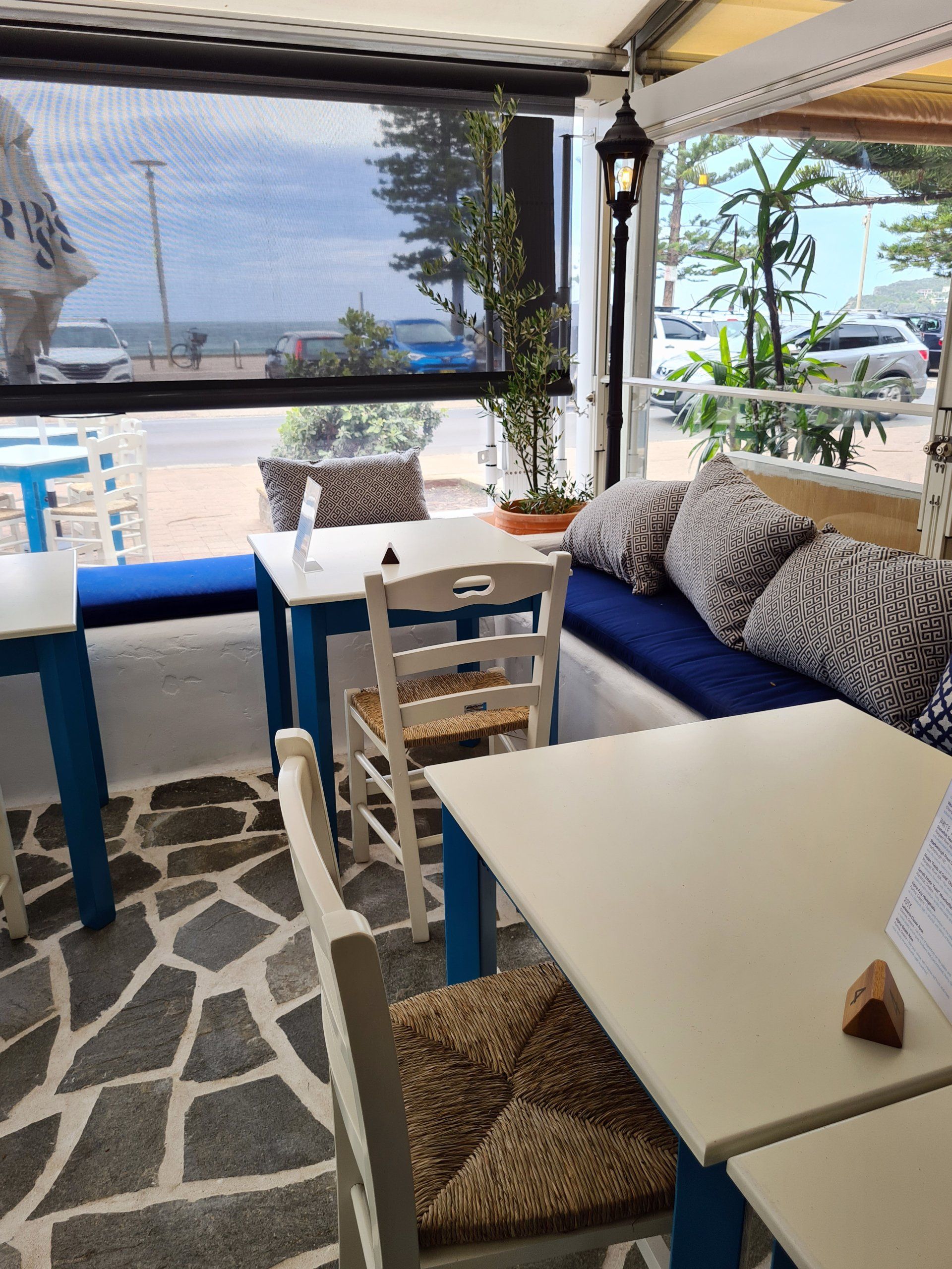 A restaurant with tables and chairs and a large window