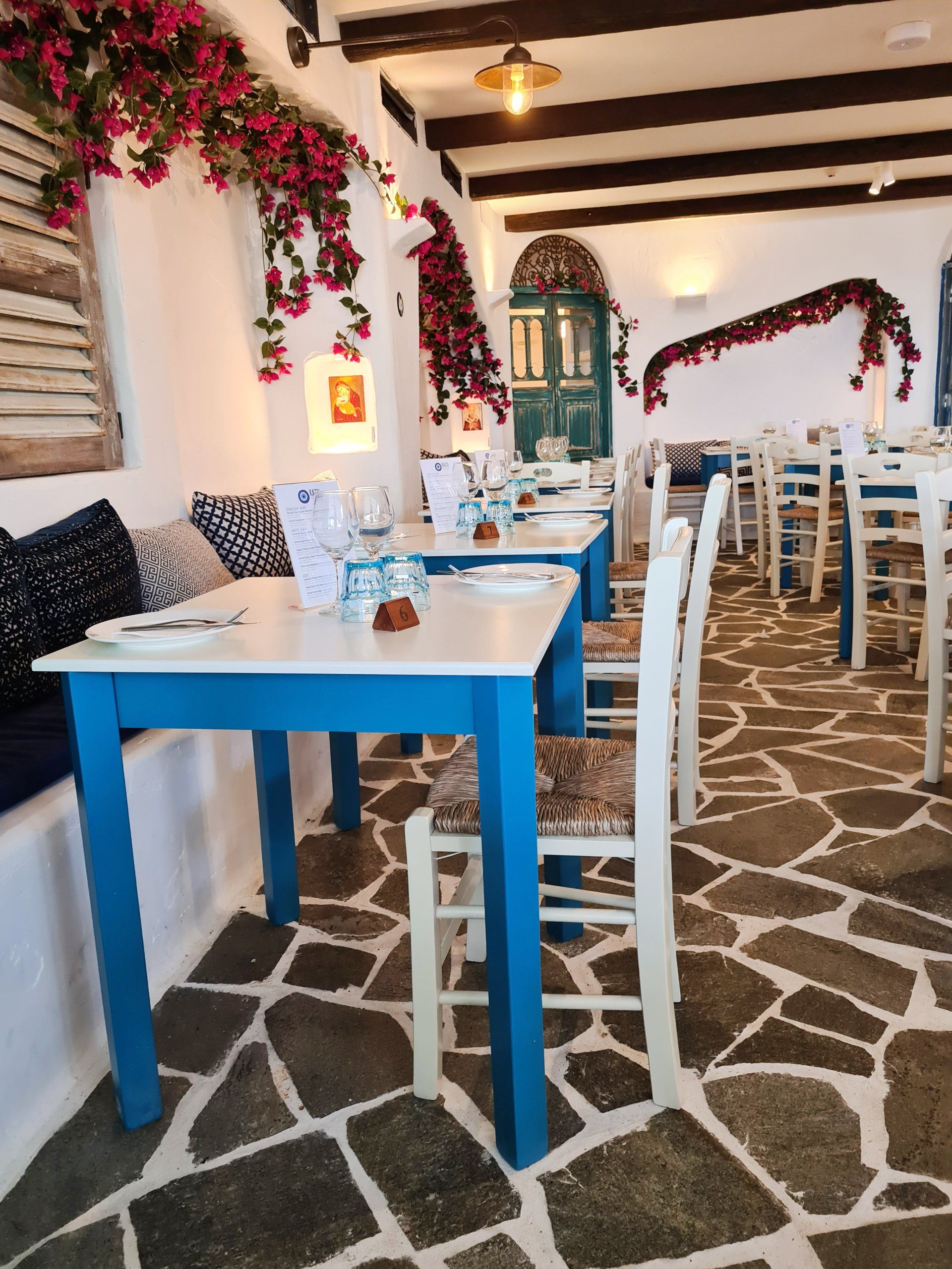 A restaurant with blue and white tables and chairs