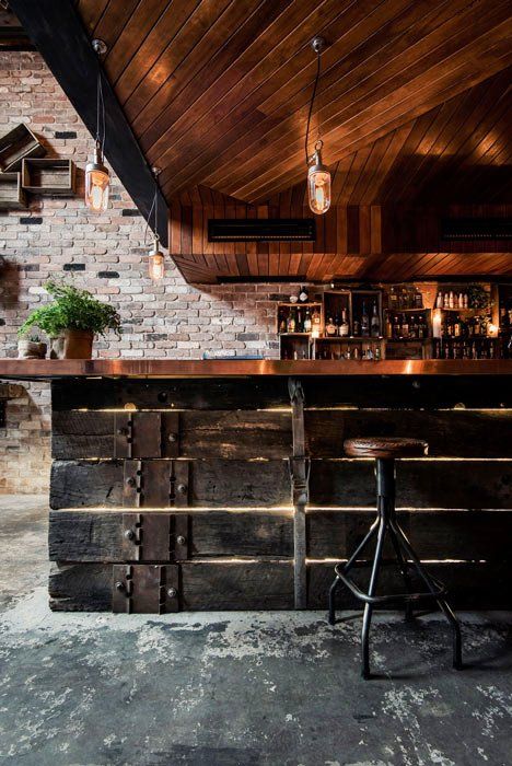 A bar with a wooden counter and a stool.