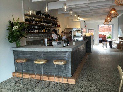 A restaurant with a long bar and stools