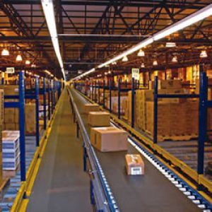 A conveyor belt in a warehouse with boxes on it