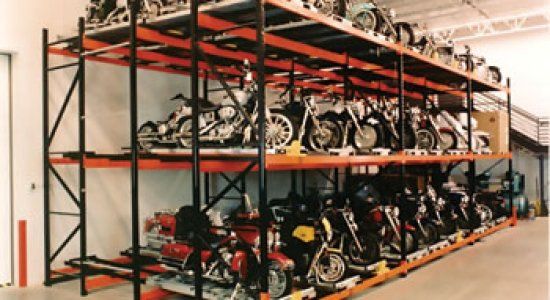 A warehouse filled with lots of motorcycles on shelves