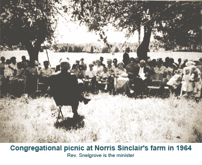 Congregational picnic at Norris Sinclair's farm in 1964, people gathered outdoors under trees.