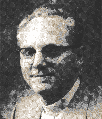 Black-and-white portrait of a man wearing glasses and a suit, facing slightly left