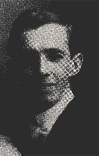 Black-and-white portrait of a man in a suit and tie, facing slightly left.