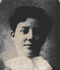 Black-and-white portrait of a person with short dark hair, wearing a light top, against a textured background.
