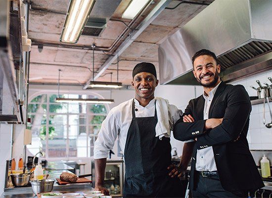Restaurant Owner With Chef In Kitchen — Newtown, PA — Piccolo Trattoria Italian Catering Restaurant Owner With Chef In Kitchen — Newtown, PA — Piccolo Trattoria Italian Catering