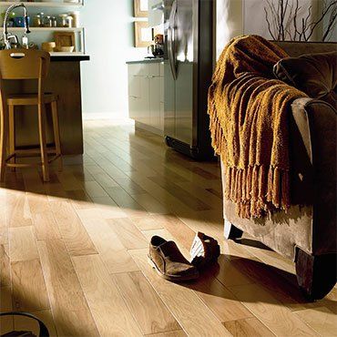 Wooden Floor and Couch With Pair Of Shoes — Ypsilanti, MI — Carpet Center & Floors