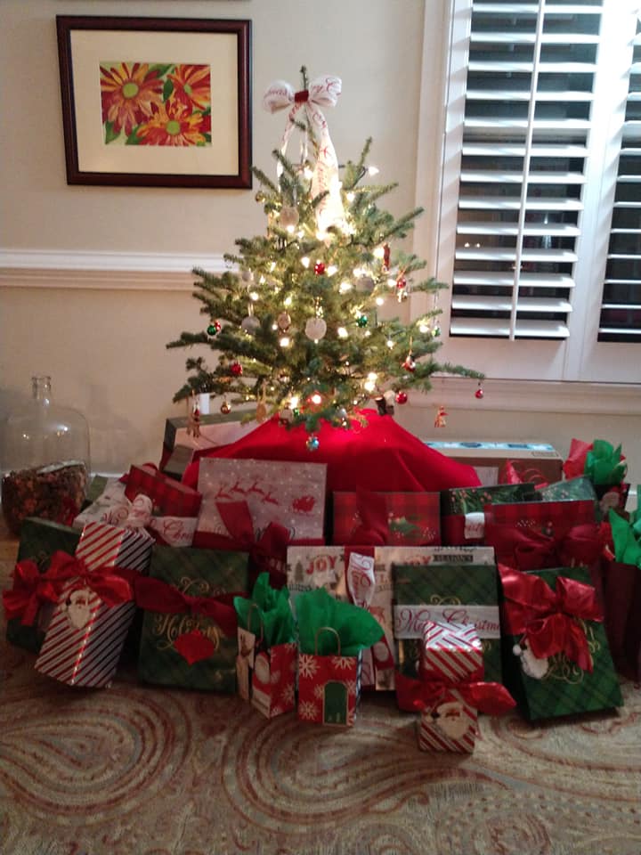 A christmas tree with lots of presents underneath it
