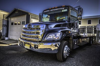 Auto Body Maintenance — Car Towed Onto Flatbed Tow Truck in Lakewood, NJ Auto Body Maintenance — Car Towed Onto Flatbed Tow Truck in Lakewood, NJ
